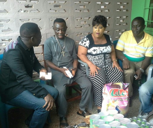 L-R: Mr Beatiful, presenting the items to J.A Adofo and his wife and other